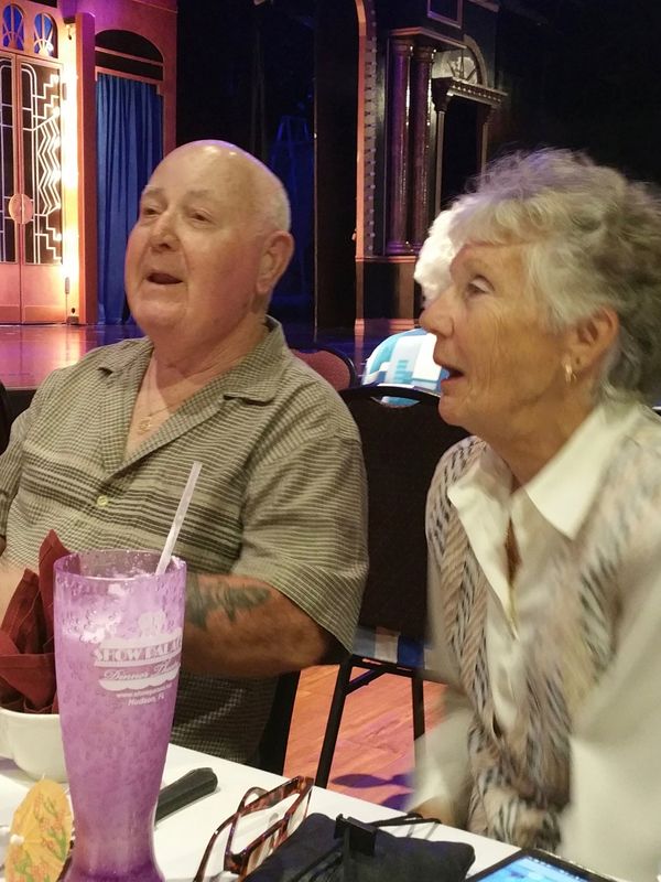 A man and woman sitting at a table for dinner theater at the Show Palace.